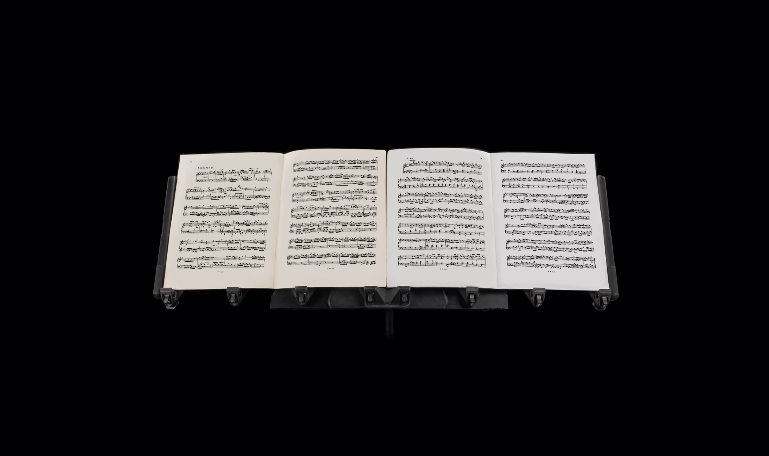 LONGA: A photo showing it extending the capabilities of a black music stand and holding two music books